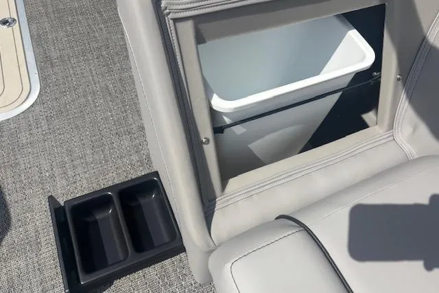 Slide: The Image of Barletta A24QC 2026 boat interior with built-in cooler and cup holders. - 10