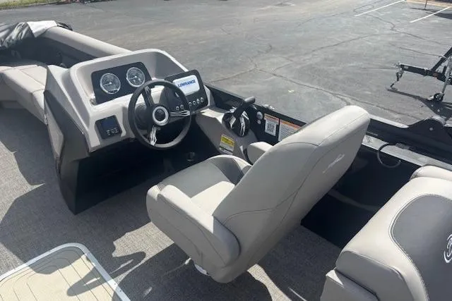 Slide: The Image of Interior view of 2026 Barletta A24QC boat, featuring modern dashboard and comfortable seating. - 7