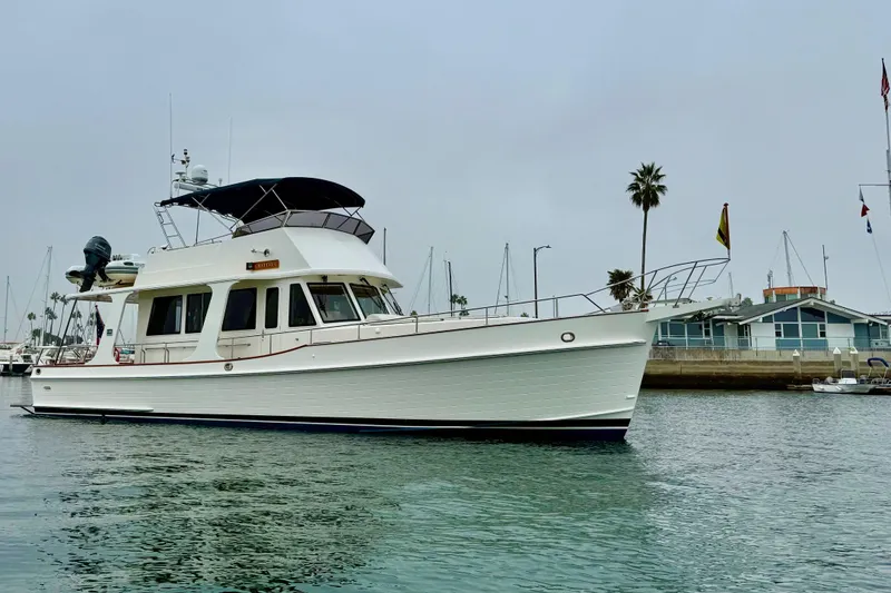 Slide: The Image of 2009 Grand Banks 47 Heritage EU yacht docked in a marina, calm waters, overcast sky. - 101