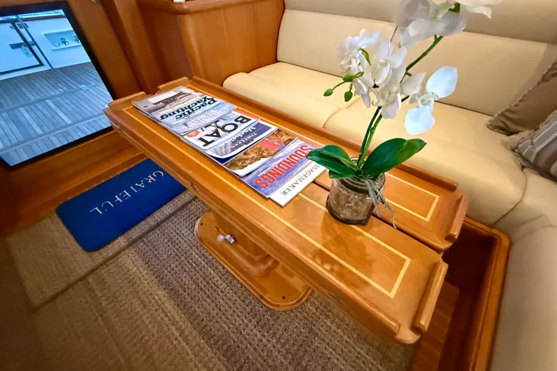 Slide: The Image of Luxurious interior of 2009 Grand Banks 47 Heritage EU with elegant wooden table and magazines. - 17