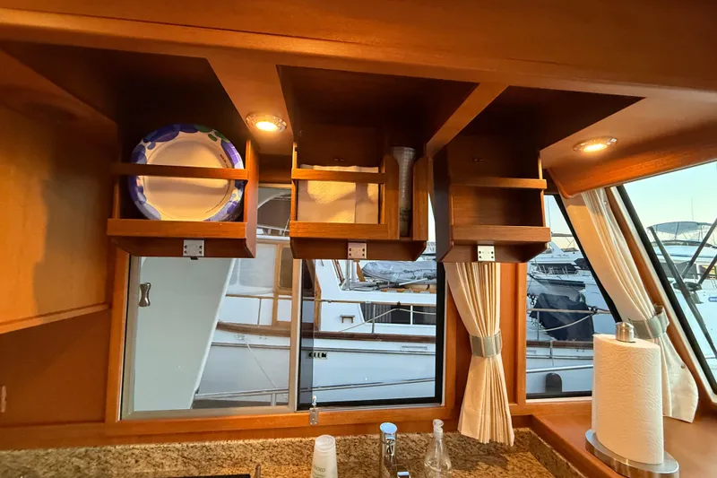 Slide: The Image of Interior of 2009 Grand Banks 47 Heritage EU yacht with wooden cabinets and window view. - 33