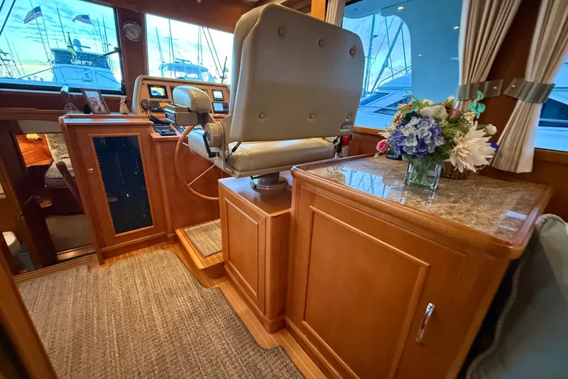 Slide: The Image of Luxurious interior of 2009 Grand Banks 47 Heritage EU yacht with helm and floral arrangement. - 35