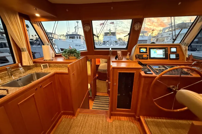 Slide: The Image of Luxurious 2009 Grand Banks 47 Heritage EU yacht interior with helm, navigation equipment, and kitchen area. - 36