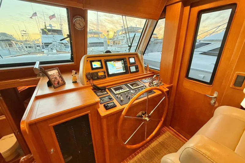 Slide: The Image of Helm of 2009 Grand Banks 47 Heritage EU yacht with navigation equipment and wooden steering wheel. - 37