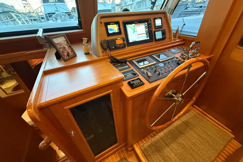 Slide: The Image of 2009 Grand Banks 47 Heritage EU helm with navigation equipment and wooden steering wheel. - 38