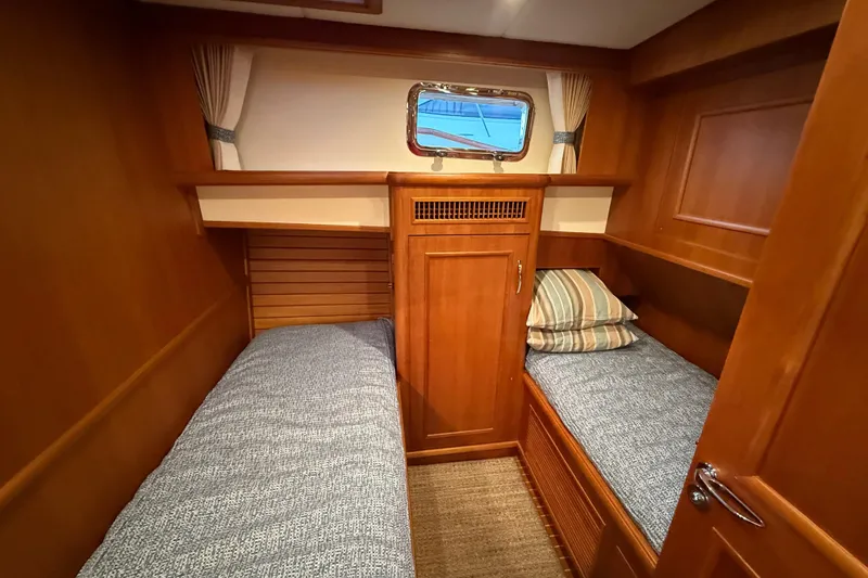 Slide: The Image of 2009 Grand Banks 47 Heritage EU cabin with twin beds and wooden interior. - 42