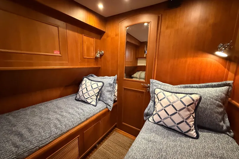 Slide: The Image of Luxurious 2009 Grand Banks 47 Heritage EU cabin with twin beds and elegant wood paneling. - 43