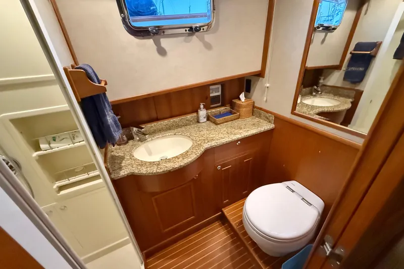 Slide: The Image of Luxurious 2009 Grand Banks 47 Heritage EU yacht bathroom with granite countertop and wooden cabinetry. - 47