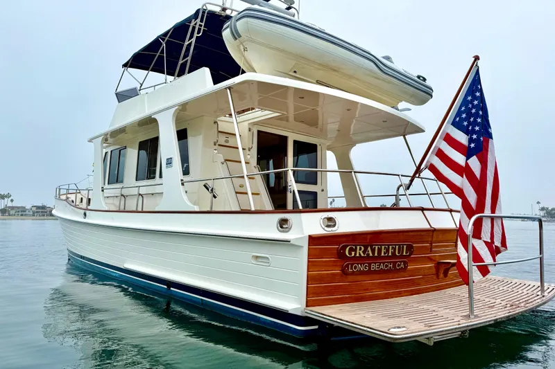 Slide: The Image of 2009 Grand Banks 47 Heritage EU yacht with American flag, docked in Long Beach, CA. - 5