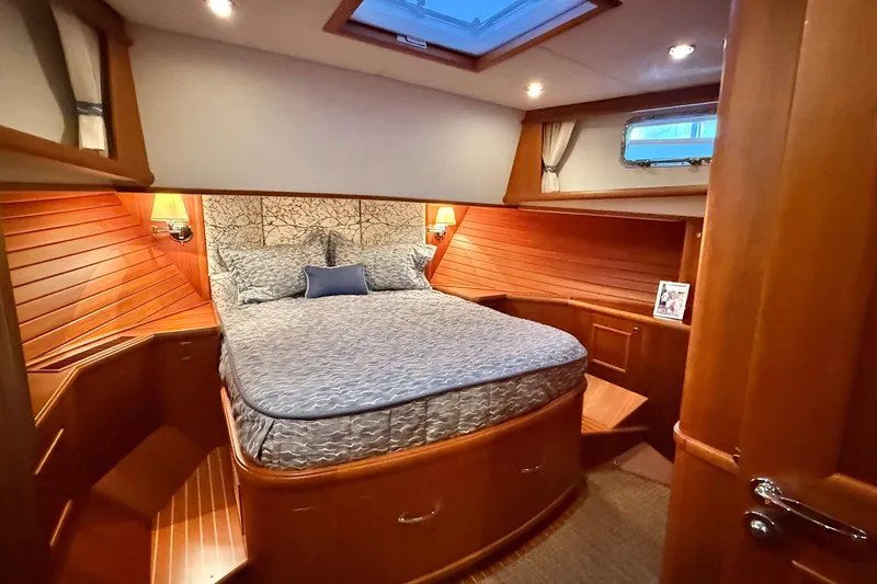 Slide: The Image of Luxurious cabin interior of 2009 Grand Banks 47 Heritage EU yacht, featuring elegant wood finishes. - 50