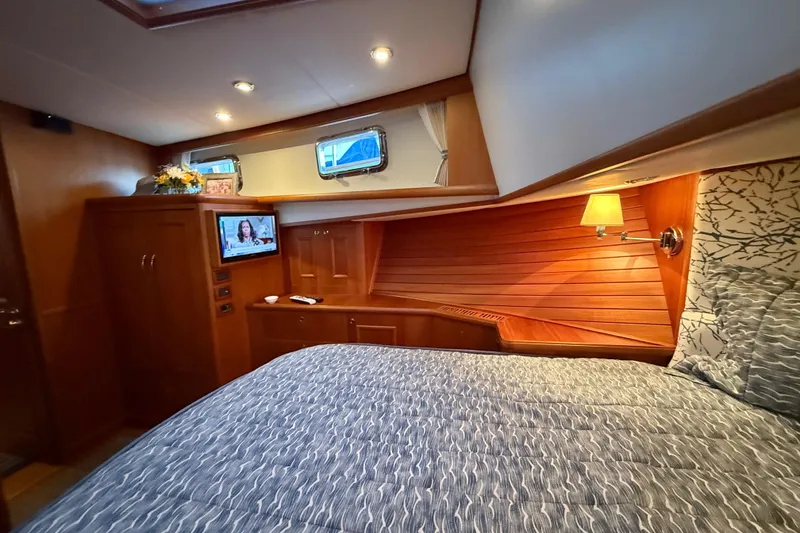 Slide: The Image of Luxurious cabin interior of 2009 Grand Banks 47 Heritage EU yacht with cozy bedding and TV. - 54
