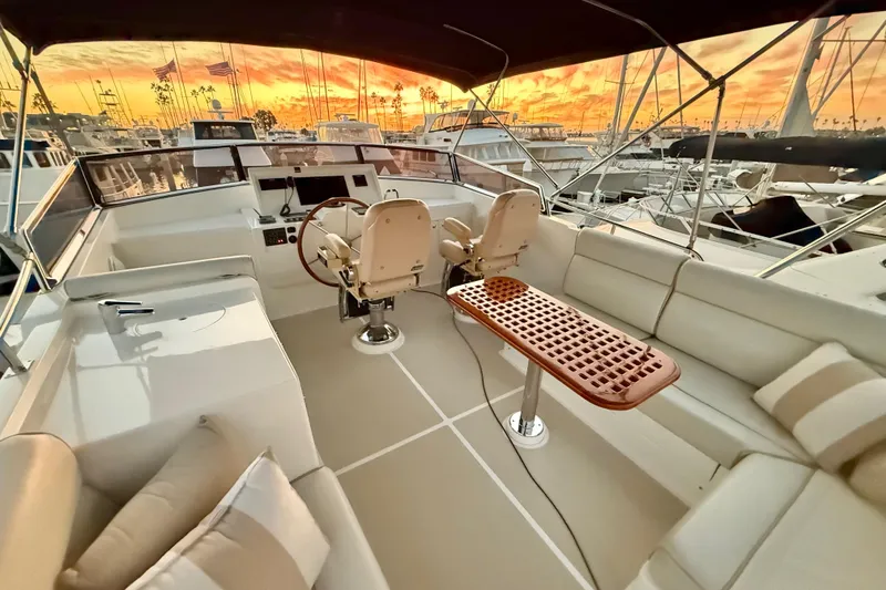 Slide: The Image of Flybridge of 2009 Grand Banks 47 Heritage EU yacht at sunset, featuring helm and seating area. - 66