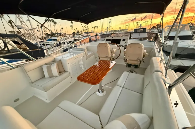 Slide: The Image of Luxurious 2009 Grand Banks 47 Heritage EU yacht interior at sunset, featuring elegant seating and helm. - 67