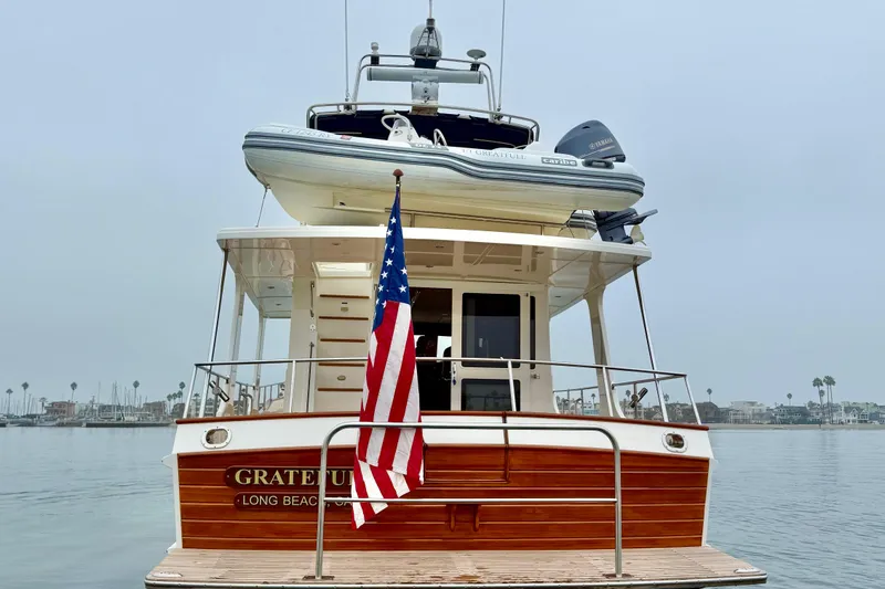 Slide: The Image of 2009 Grand Banks 47 Heritage EU yacht with American flag, docked in Long Beach. - 7