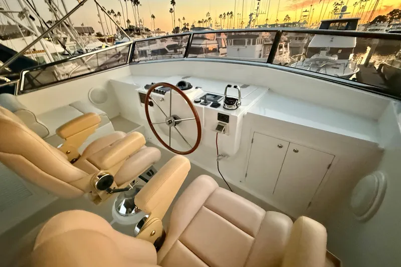 Slide: The Image of 2009 Grand Banks 47 Heritage EU yacht helm with leather seats at sunset in marina. - 73