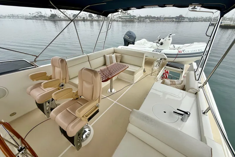 Slide: The Image of Luxurious 2009 Grand Banks 47 Heritage EU yacht deck with seating and tender boat. - 76