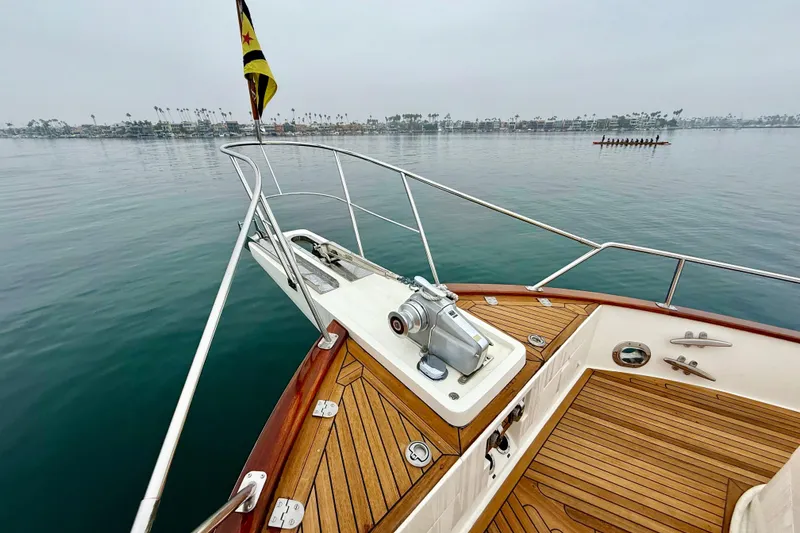 Slide: The Image of Bow of 2009 Grand Banks 47 Heritage EU yacht with teak deck and calm waters. - 81
