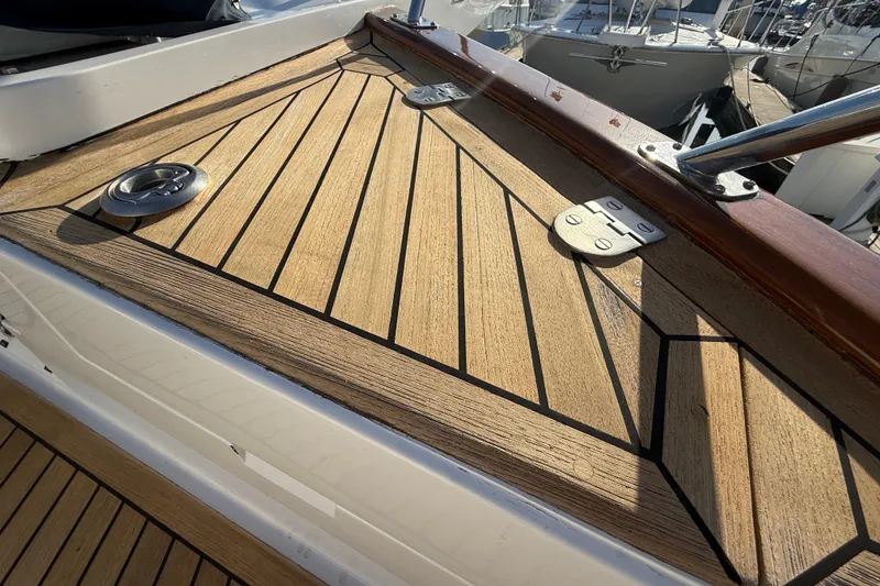 Slide: The Image of Teak deck detail on 2009 Grand Banks 47 Heritage EU yacht, featuring metal fixtures. - 87