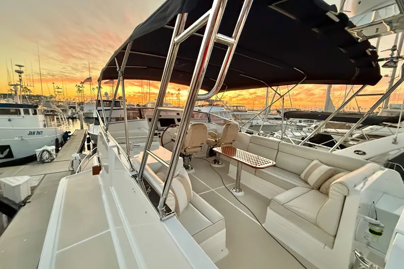 Slide: The Image of 2009 Grand Banks 47 Heritage EU yacht with elegant seating, docked at sunset. - 96