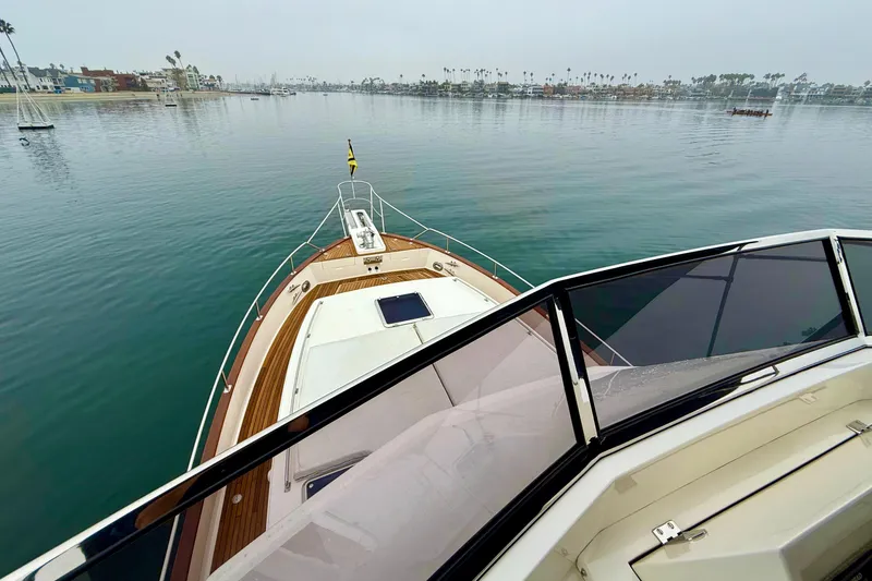 Slide: The Image of 2009 Grand Banks 47 Heritage EU yacht cruising on calm waters, scenic coastal view. - 98