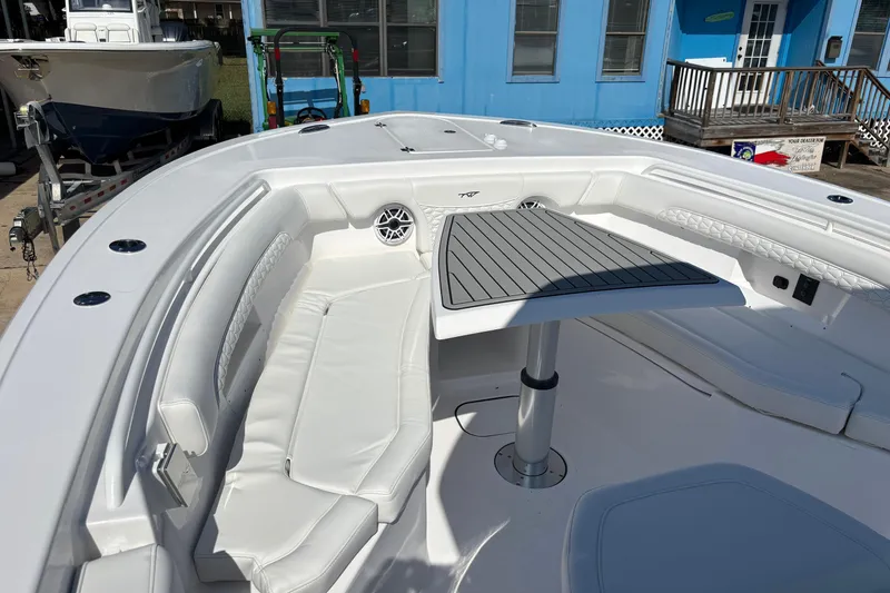 Slide: The Image of 2026 Tidewater 272 LXF boat interior with white seating and a central table. - 10