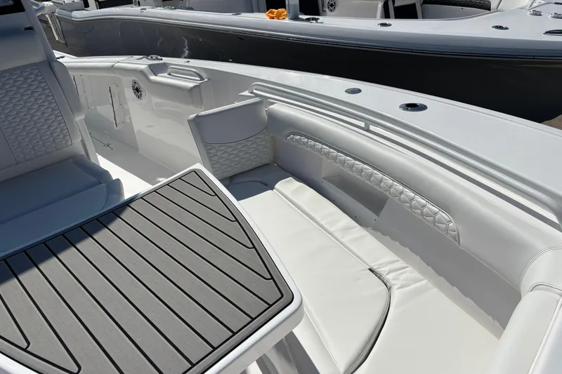 Slide: The Image of 2026 Tidewater 272 LXF boat interior with cushioned seating and sleek design. - 11