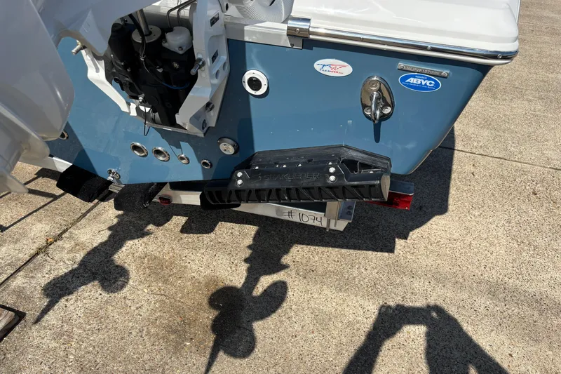 Slide: The Image of 2026 Tidewater 272 LXF boat stern with motor and trim tabs on concrete. - 4