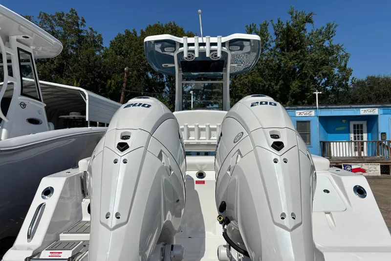 Slide: The Image of 2026 Tidewater 272 LXF boat with dual 200 horsepower engines, docked outdoors. - 5