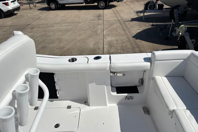 Slide: The Image of 2026 Tidewater 272 LXF boat interior with white seating and rod holders. - 7