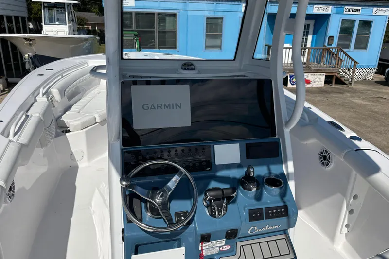 Slide: The Image of 2026 Tidewater 272 LXF boat cockpit with Garmin navigation system and sleek design. - 8