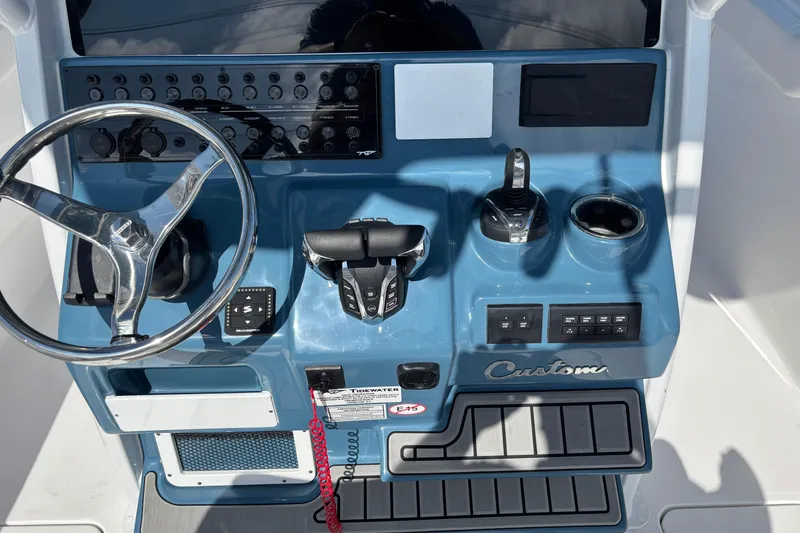 Slide: The Image of 2026 Tidewater 272 LXF boat dashboard with steering wheel and control panel. - 9