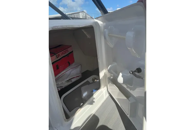 Slide: The Image of 2019 Yamaha Boats 242 Limited S interior storage with life jackets and accessories. - 10