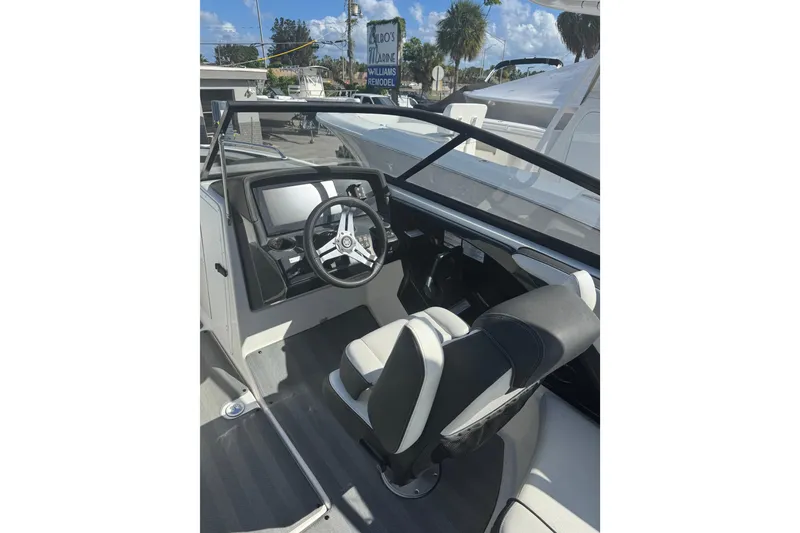 Slide: The Image of 2019 Yamaha Boats 242 Limited S cockpit with steering wheel and seating. - 6