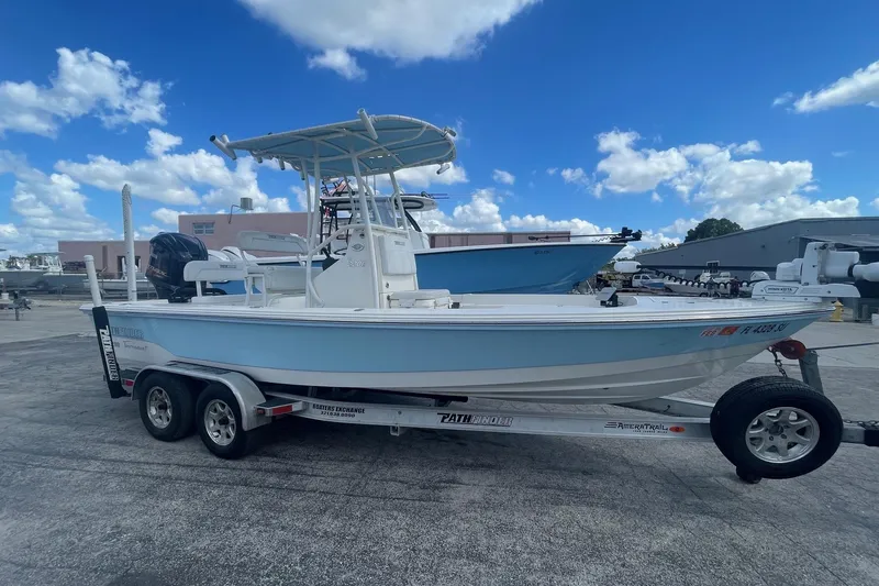 Slide: The Image of 2020 Pathfinder 2200 Tournament Edition boat on trailer under blue sky. - 4