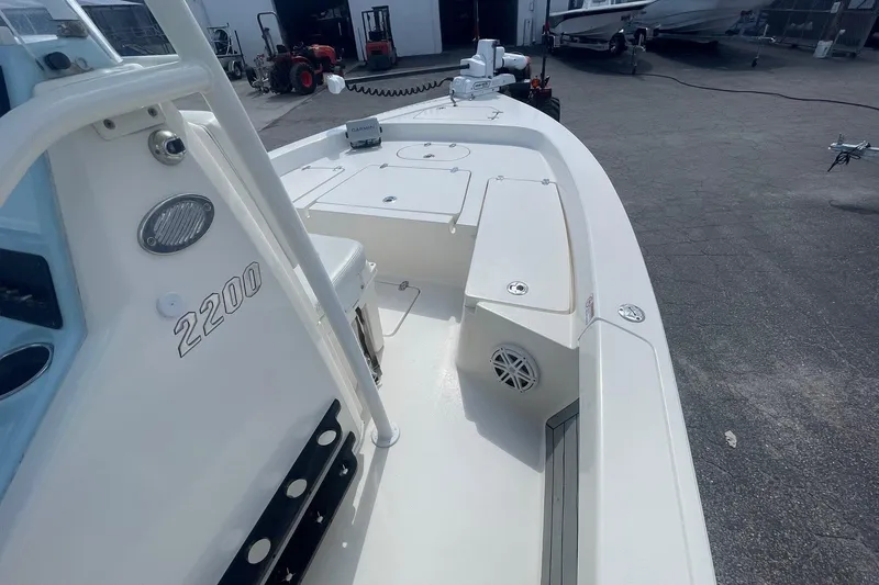 Slide: The Image of 2020 Pathfinder 2200 Tournament Edition boat, white deck, parked in a marina. - 6