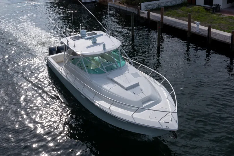 The Image of 2011 SeaVee 430 Sport Express boat cruising on a sunny waterway. - 1