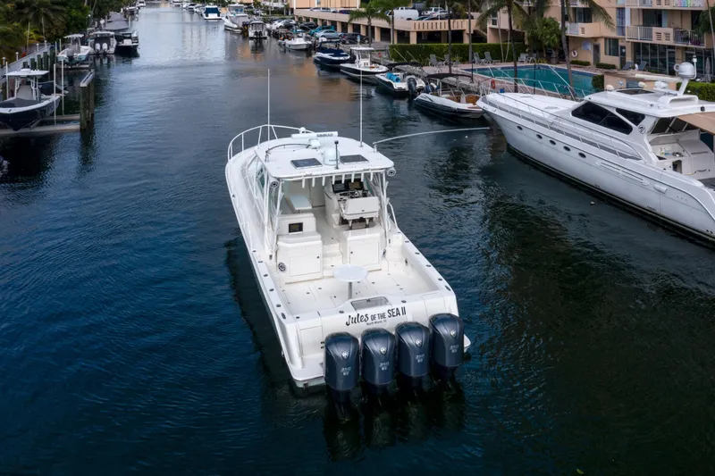 Slide: The Image of 2011 SeaVee 430 Sport Express yacht docked in a scenic marina. - 11