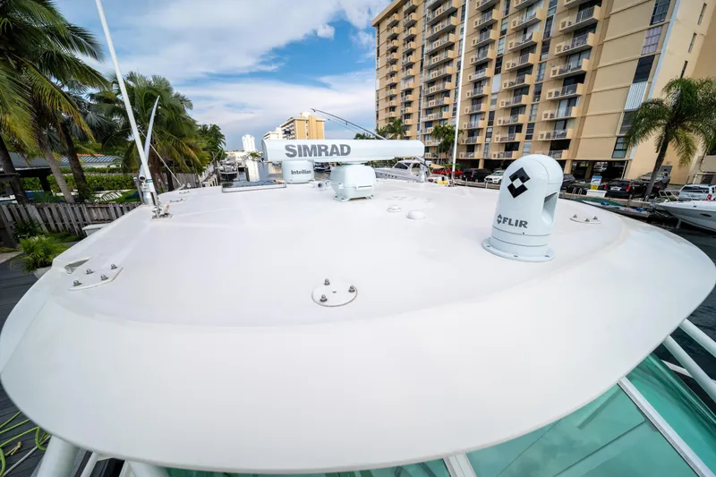 Slide: The Image of 2011 SeaVee 430 Sport Express yacht with advanced navigation equipment docked near palm trees. - 12