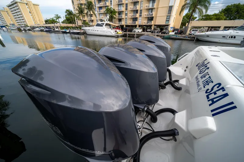 Slide: The Image of 2011 SeaVee 430 Sport Express with four powerful outboard engines docked in a marina. - 13