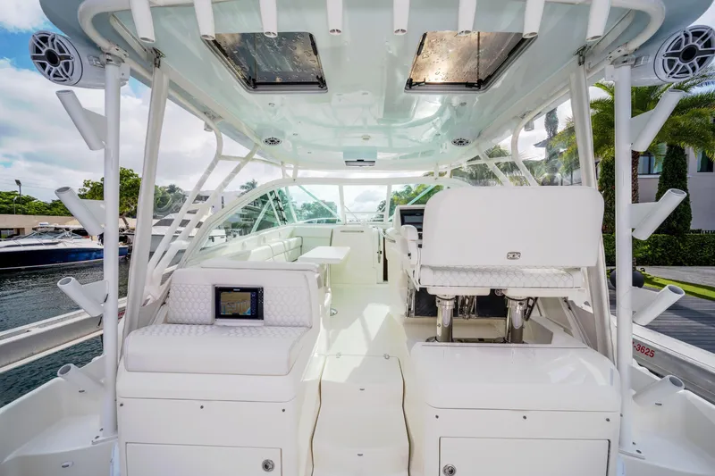 Slide: The Image of 2011 SeaVee 430 Sport Express boat interior with white seating and modern design. - 15
