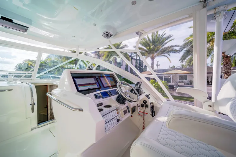 Slide: The Image of 2011 SeaVee 430 Sport Express helm with modern controls and panoramic view. - 19