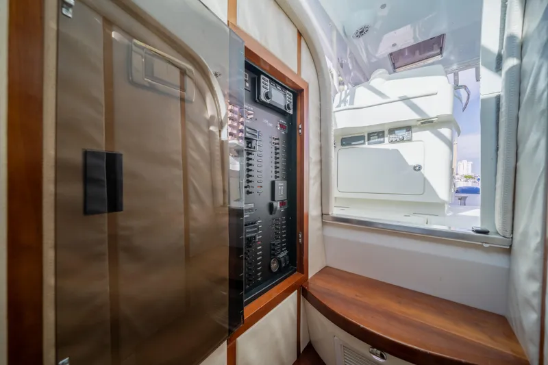 Slide: The Image of 2011 SeaVee 430 Sport Express interior with control panel and wooden seating. - 21