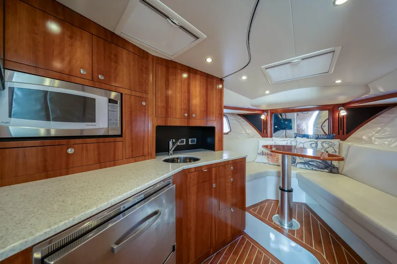 Slide: The Image of Luxurious interior of 2011 SeaVee 430 Sport Express with modern kitchen and cozy seating area. - 23
