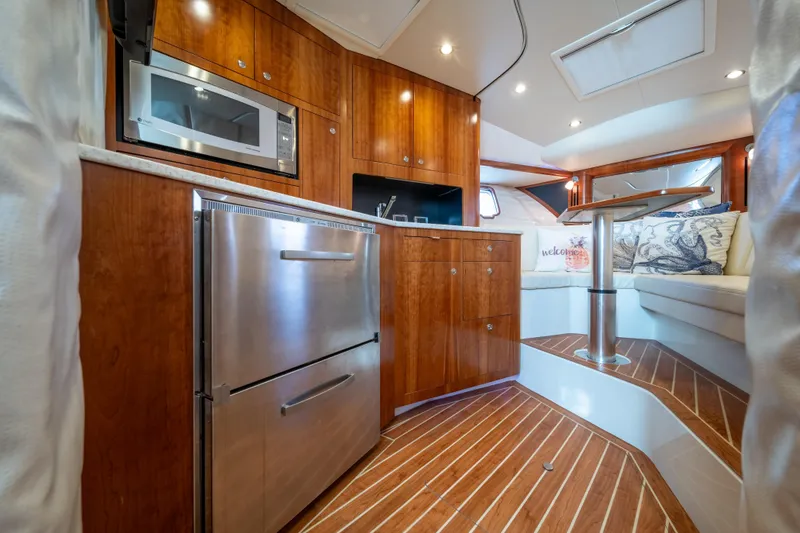 Slide: The Image of Luxurious interior of 2011 SeaVee 430 Sport Express with wood cabinetry and modern appliances. - 24