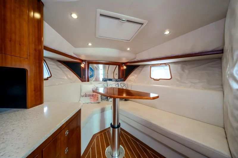 Slide: The Image of Luxurious interior of 2011 SeaVee 430 Sport Express with cozy seating and elegant wood finishes. - 27