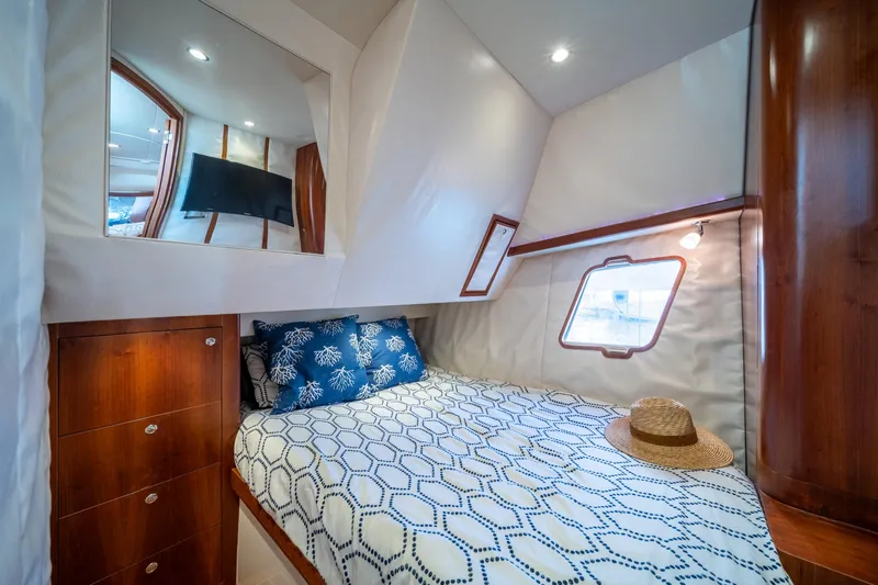 Slide: The Image of Luxurious cabin interior of 2011 SeaVee 430 Sport Express with cozy bed and stylish decor. - 28