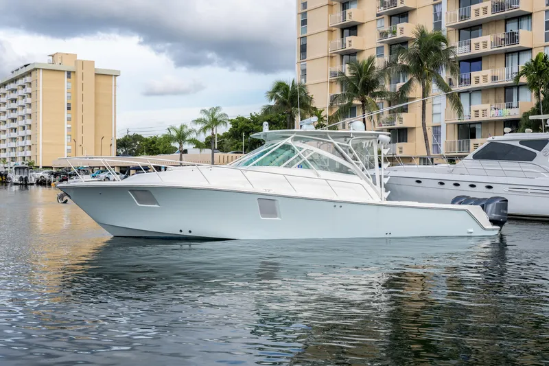 Slide: The Image of 2011 SeaVee 430 Sport Express boat docked near waterfront buildings. - 4