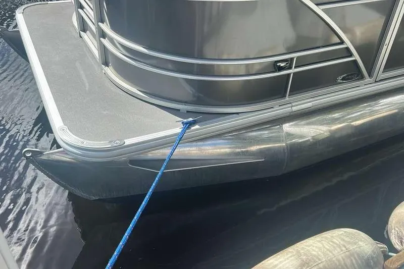 Slide: The Image of 2023 Sylvan Mirage 820 LZ pontoon boat docked with blue rope. - 10