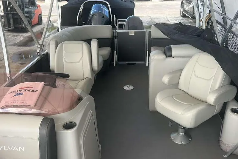 Slide: The Image of 2023 Sylvan Mirage 820 LZ pontoon boat interior with plush seating and modern design. - 4