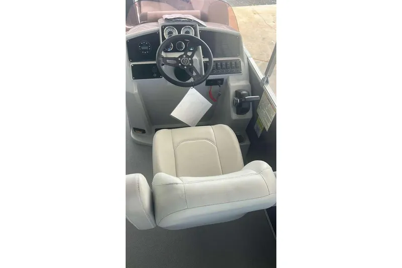 Slide: The Image of 2023 Sylvan Mirage 820 LZ boat helm with steering wheel and captain's chair. - 5